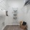 walk-in closet with shelving and lighting